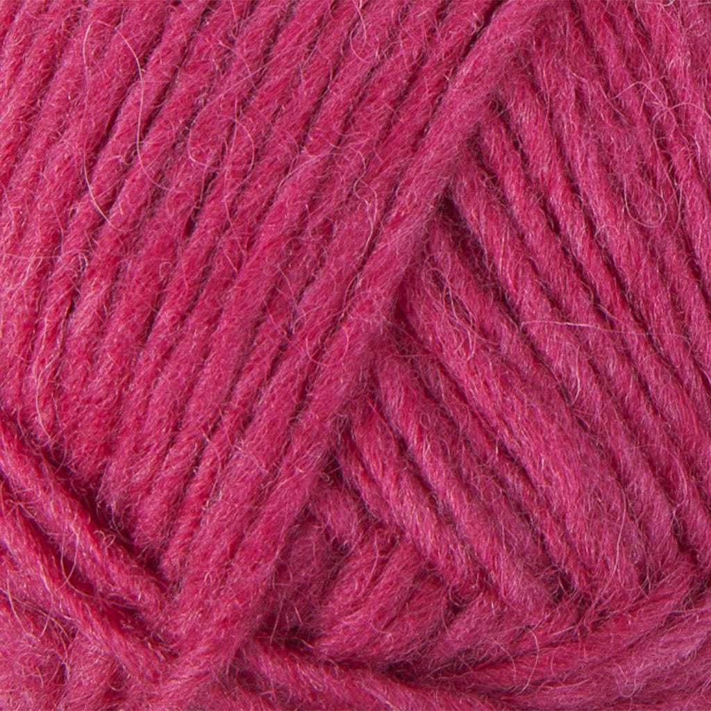 Dark Magenta 1240, a bright barbie pink skein of Lopi's Álafosslopi, a bulky Icelandic wool yarn.