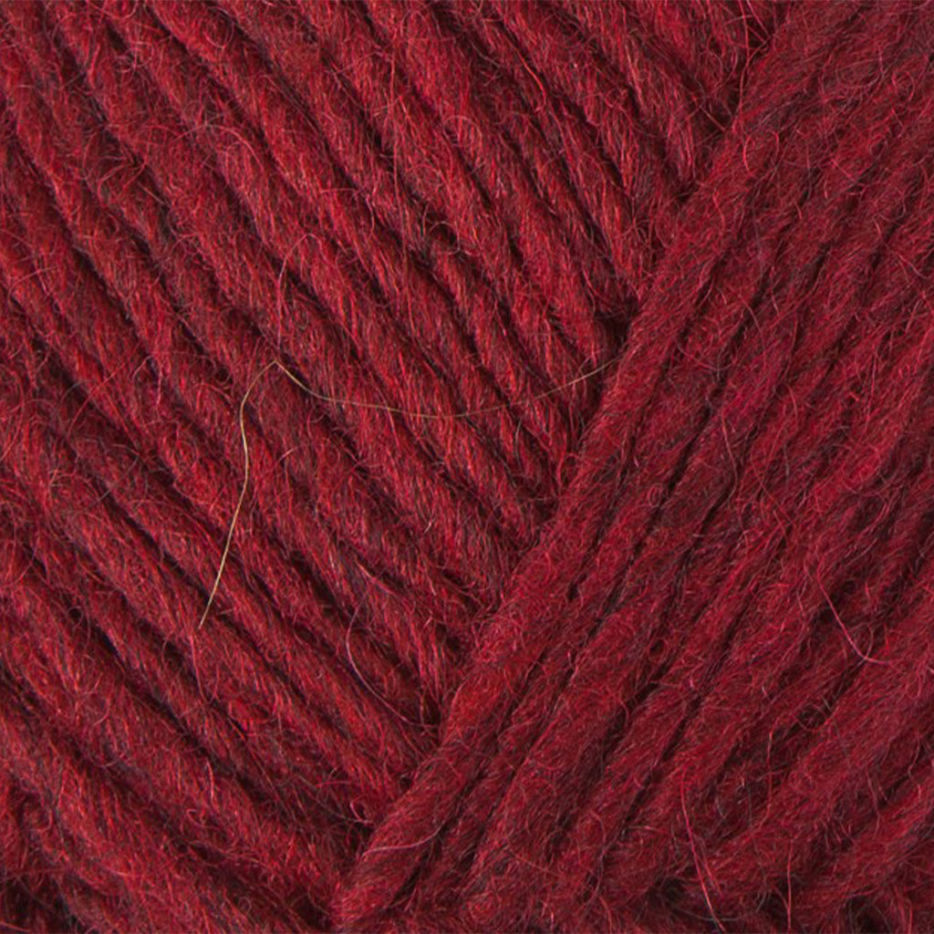 Dusk Red 1238, a dark heathered red skein of Lopi's Álafosslopi, a bulky Icelandic wool yarn.