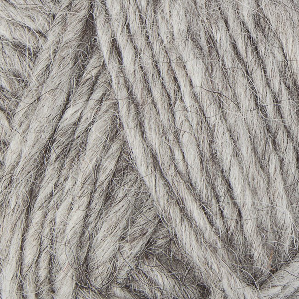 Light Grey 0056, a light heathered grey skein of Lopi's Álafosslopi, a bulky Icelandic wool yarn.