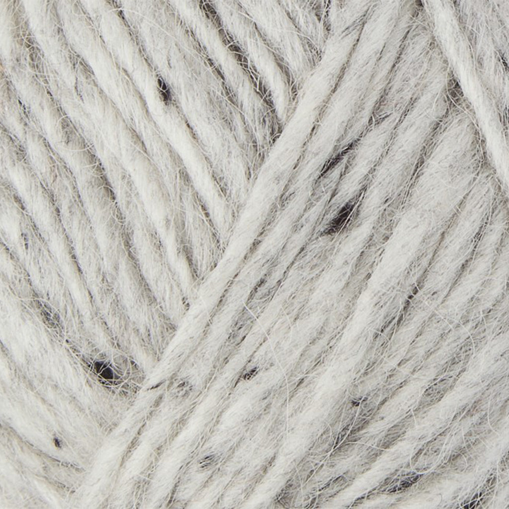 Light Grey Tweed 9974, a white with dark grey flecks skein of Lopi's Álafosslopi, a bulky yarn.