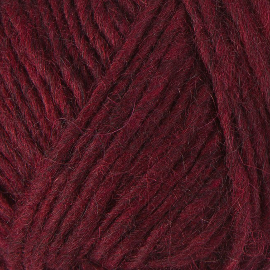 Oxblood Red 1242, a dark blood red skein of Lopi's Álafosslopi, a bulky Icelandic wool yarn.
