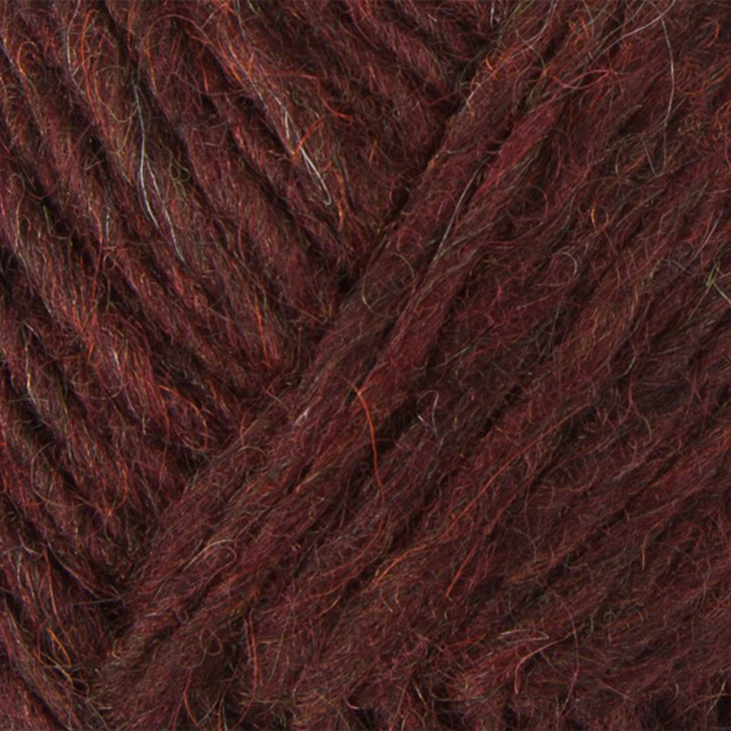 Sheep Sorrel 1237, a maroon skein of Lopi's Álafosslopi, a bulky Icelandic wool yarn.