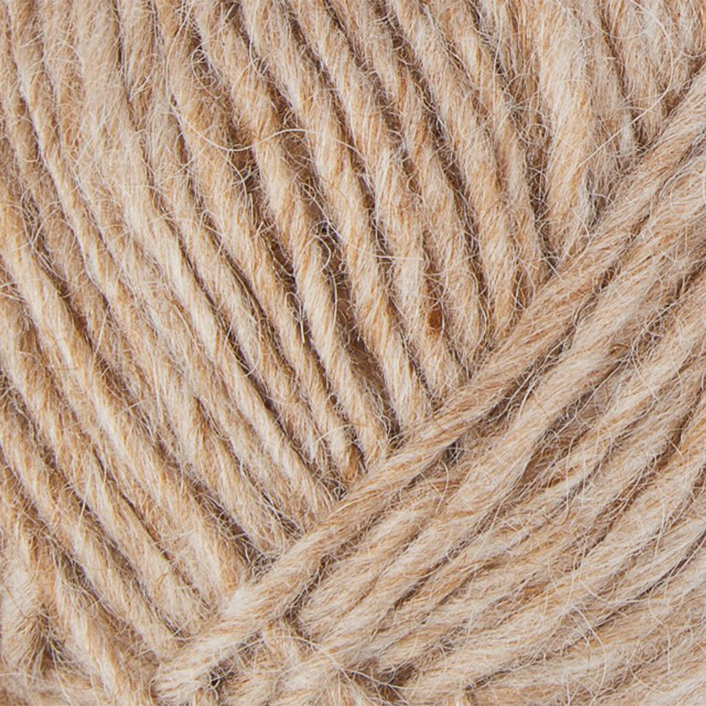 Wheat 9973, a light heathered golden brown skein of Lopi's Álafosslopi, a bulky wool yarn.
