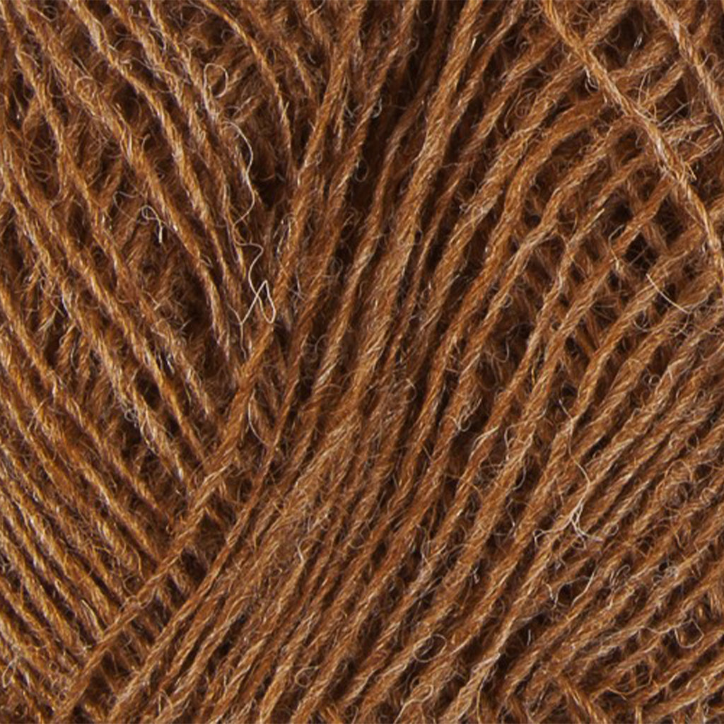 Almond 9076, a heathered golden brown skein of Lopi's Einband Icelandic wool lace yarn.