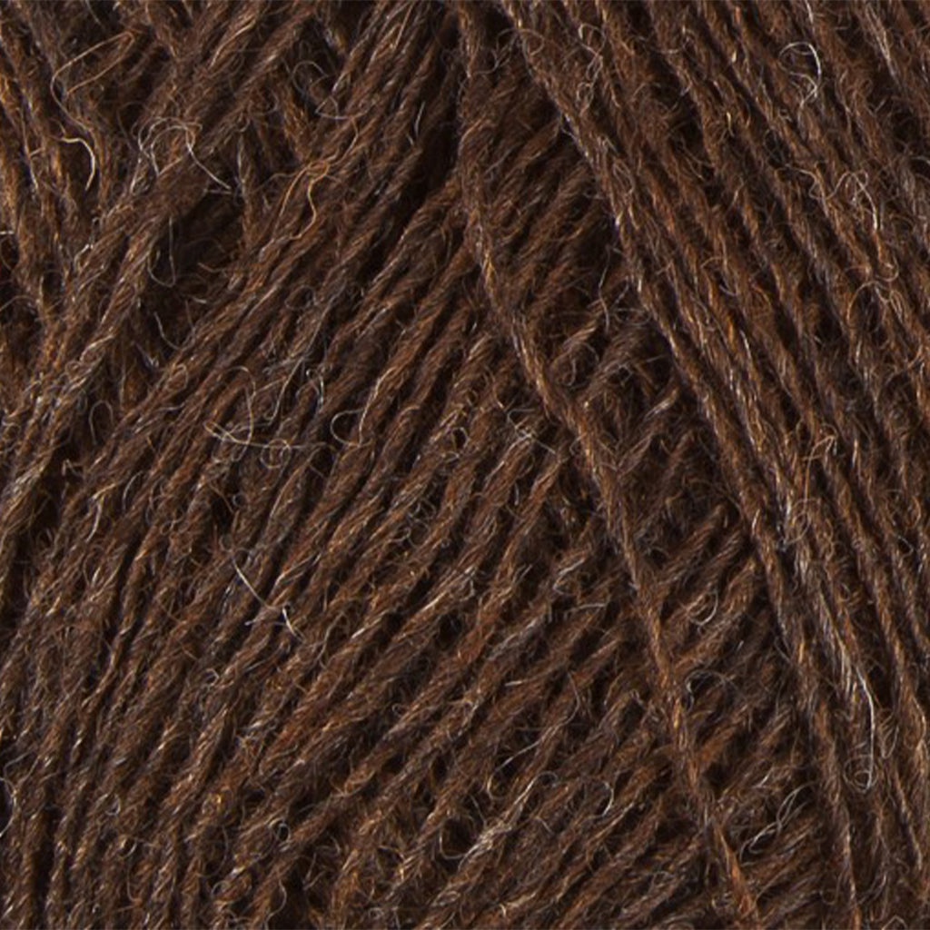 Chocolate 0867, a warm heathered brown skein of Lopi's Einband Icelandic wool lace yarn.