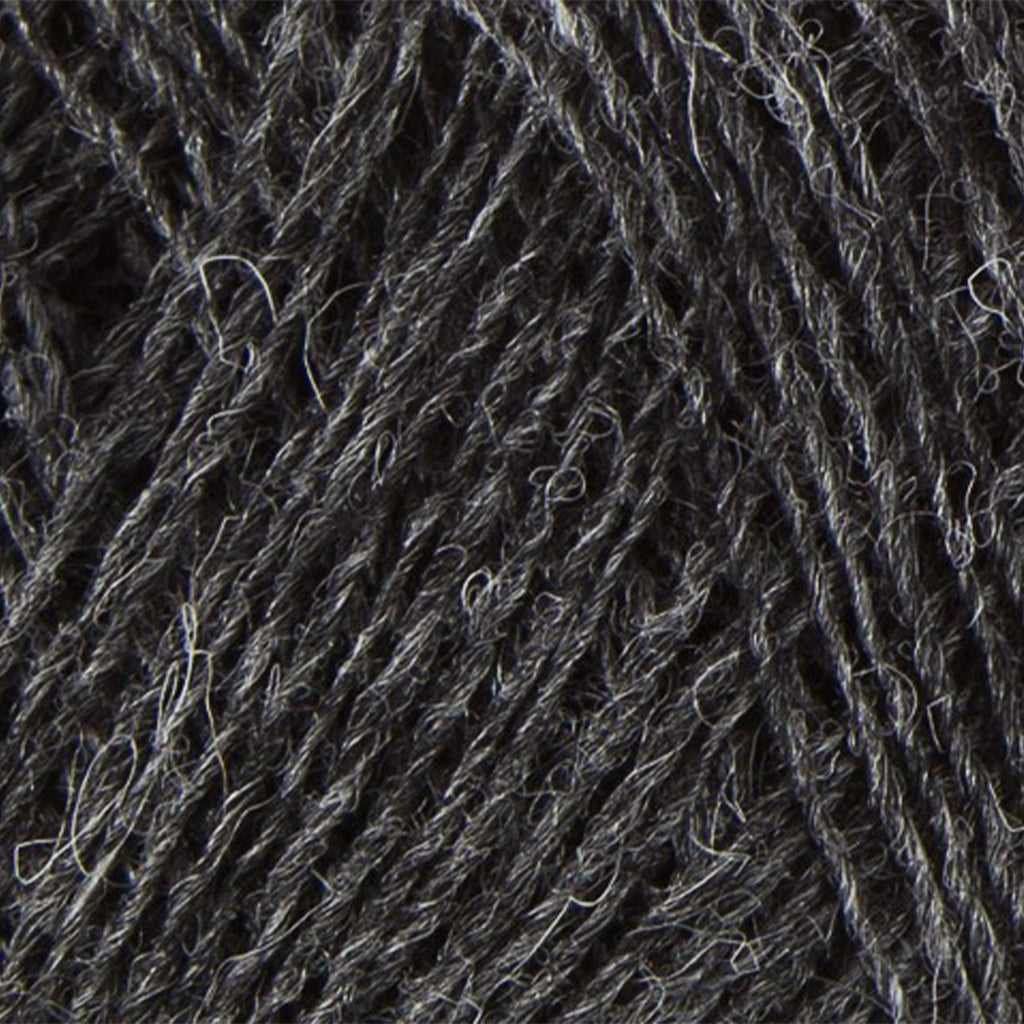 Dark Grey 9103, a dark heathered grey skein of Lopi's Einband Icelandic wool lace yarn.