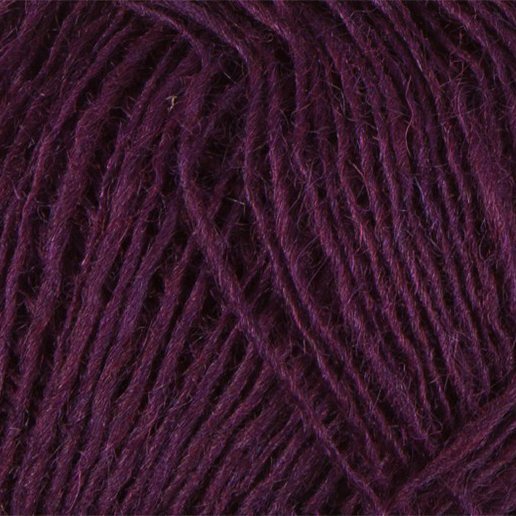 Dark Wine 9020, a dark burgudy purple skein of Lopi's Einband Icelandic wool lace yarn.