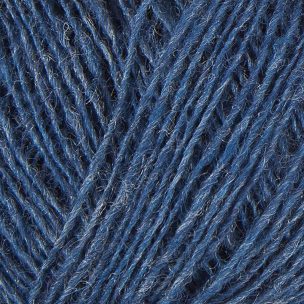 Denim Heather 0010, a medium heathered blue skein of Lopi's Einband Icelandic wool lace yarn.