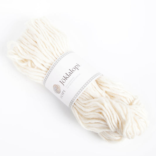 A hank of Lopi's Super Bulky wool yarn Jöklalopi in the color White 0051.