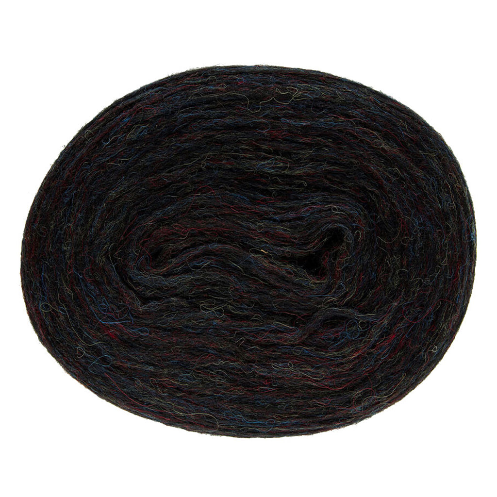 Black Cosmos 2024, a heathered black roll of Lopi's Plotulopi with strands of blue, red, and yellow.