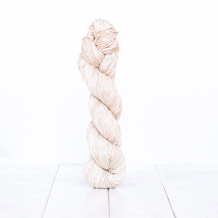1201, a nearly white skein of Urth Yarn's hand-dyed Monokrom Cotton DK weight yarn.