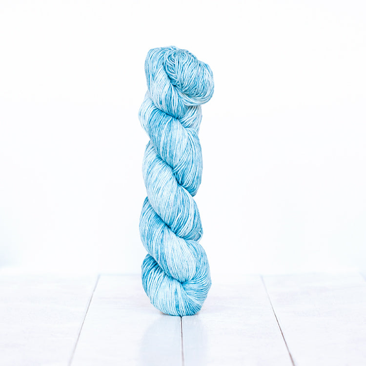 1204, a light sky blue skein of Urth Yarn's hand-dyed Monokrom Cotton DK weight yarn.