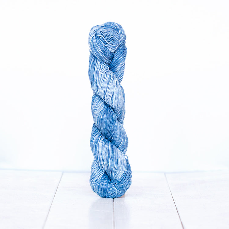1207, a bright denim blue skein of Urth Yarn's hand-dyed Monokrom Cotton DK weight yarn.
