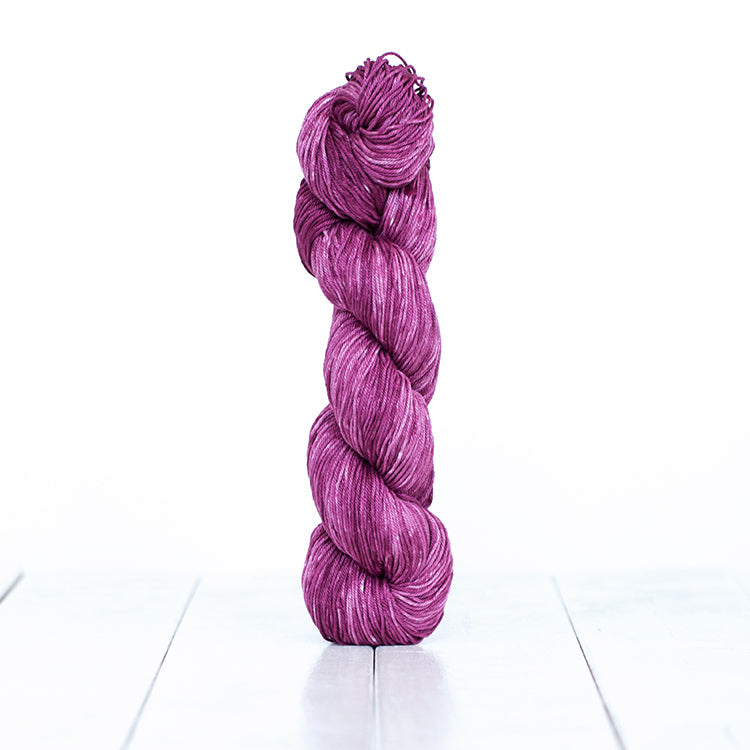 1218, a dusty plum skein of Urth Yarn's hand-dyed Monokrom Cotton DK weight yarn.