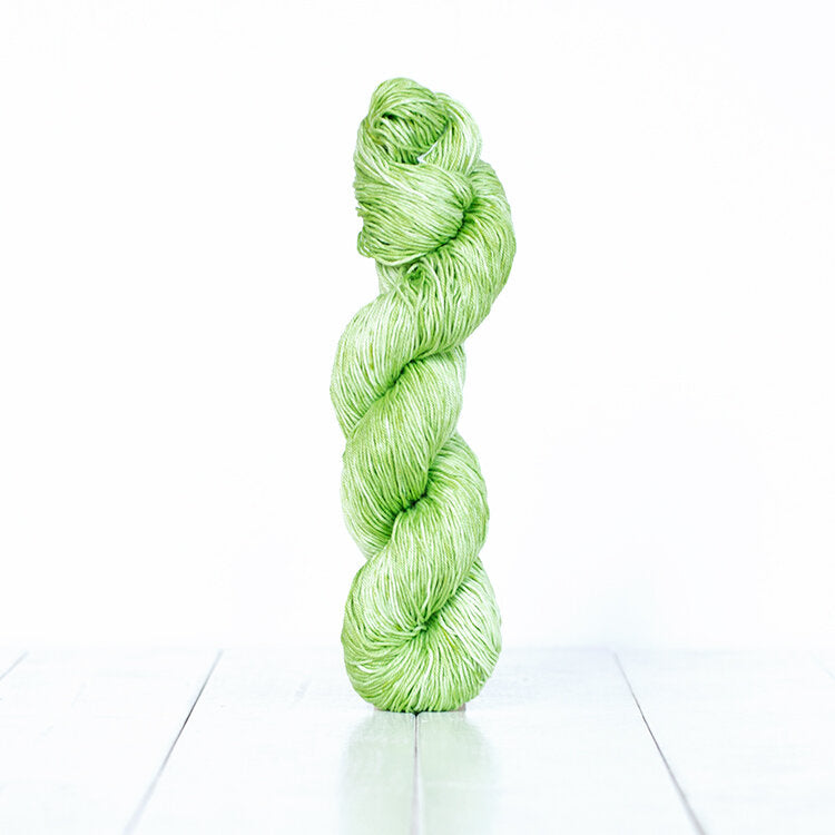 1221, a spring green skein of Urth Yarn's hand-dyed Monokrom Cotton DK weight yarn.