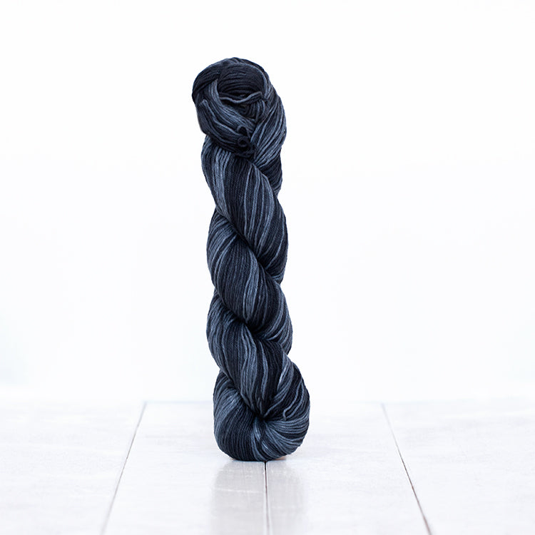 1224, a mostly black grey scale skein of Urth Yarn's hand-dyed Monokrom Cotton DK weight yarn.
