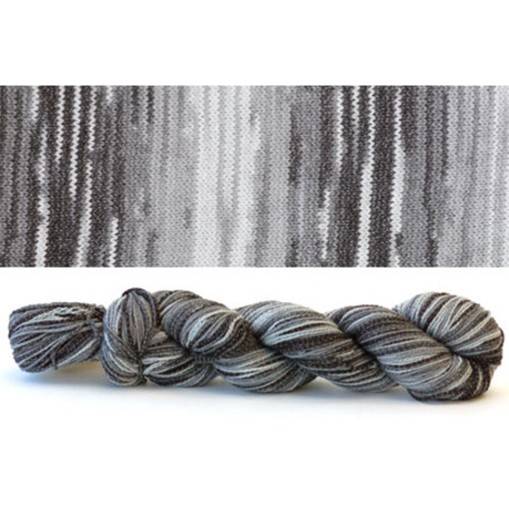 CoBaSi fingering in the color Slated 813, a self-striping colorway with grey and white stripes.