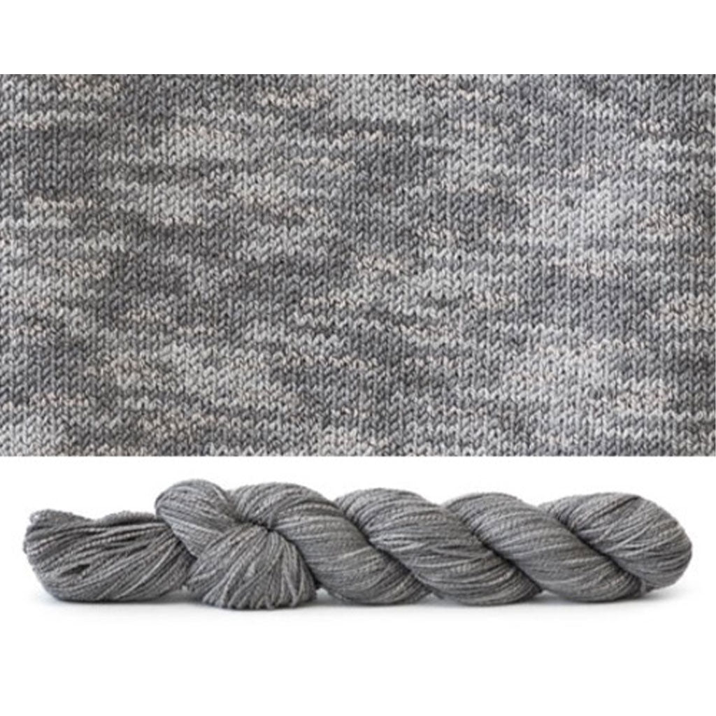 CoBaSi fingering in the color Seattle Tonal 938, a grey colorway with tonal color variation.
