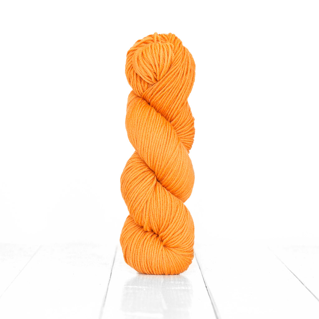Color Orange, hand-dyed skein of yarn, vibrant orange yellow color produced from natural oranges.