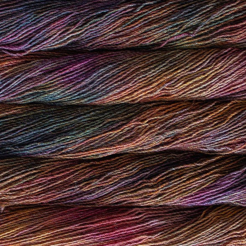 Malabrigo Dos Tierras DK Yarn in Piedras - a variegated orange, purple, pink and green colorway