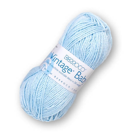 A skein of Berroco's Vintage Baby DK yarn in the color Sky Blue 10008, a pastel blue.