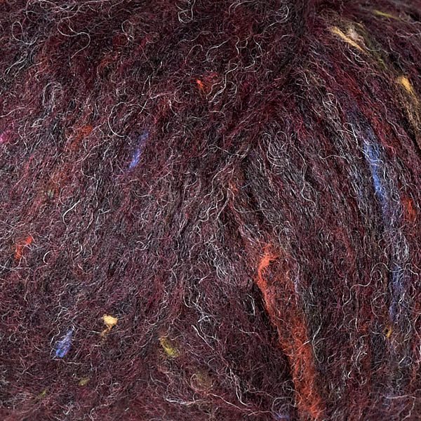 Aubergine 3248, a speckled dark burgundy ball of Berroco's Mochi yarn.