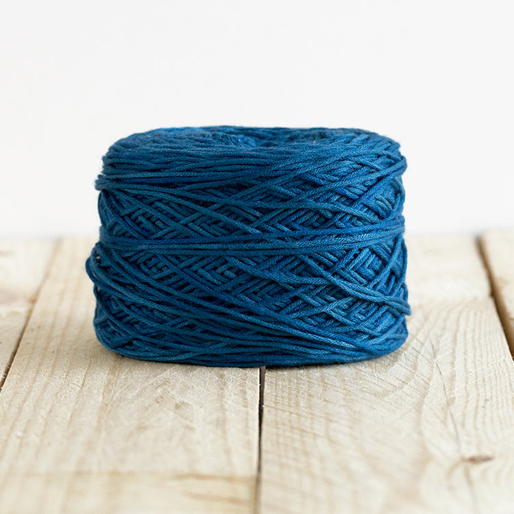 Color 5004, a dark but vibrant blue cake of yarn.