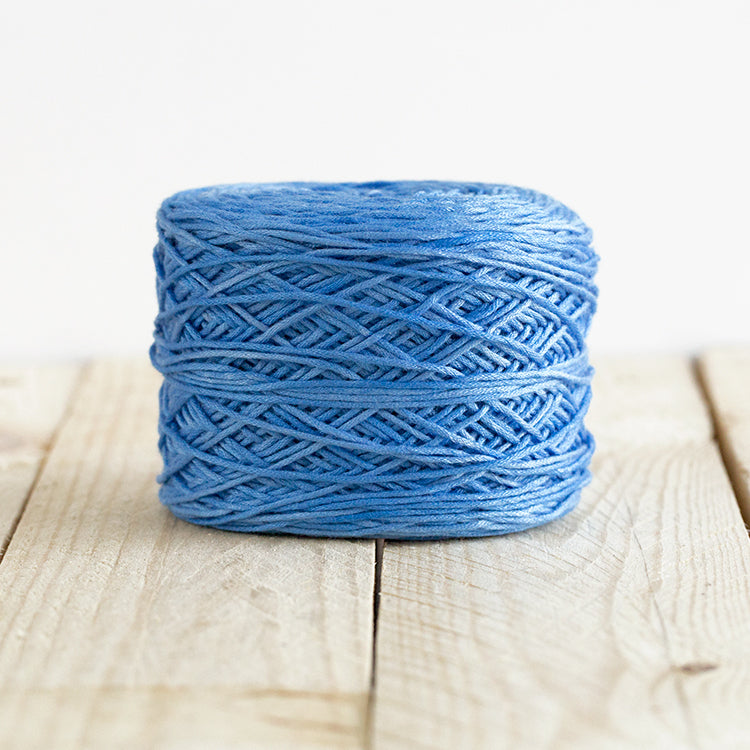 Color 5006, a sky blue cake of yarn.