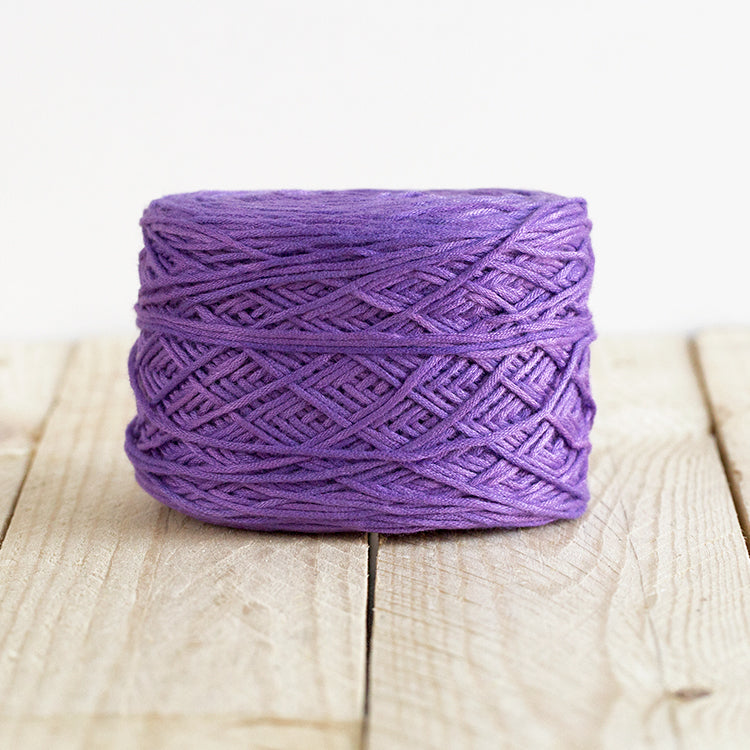 Color 5008, a rich bright violet cake of yarn.