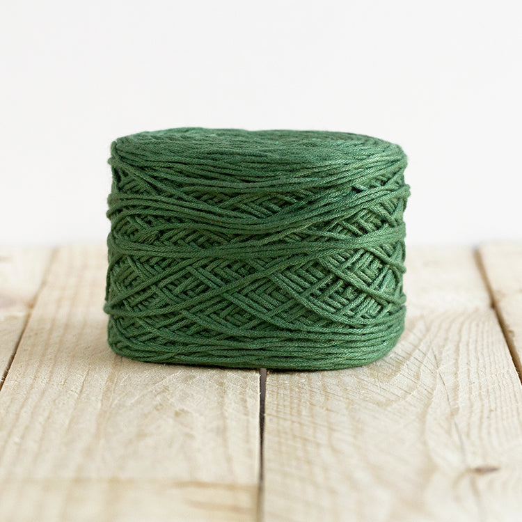 Color 5009, a forest green cake of yarn.