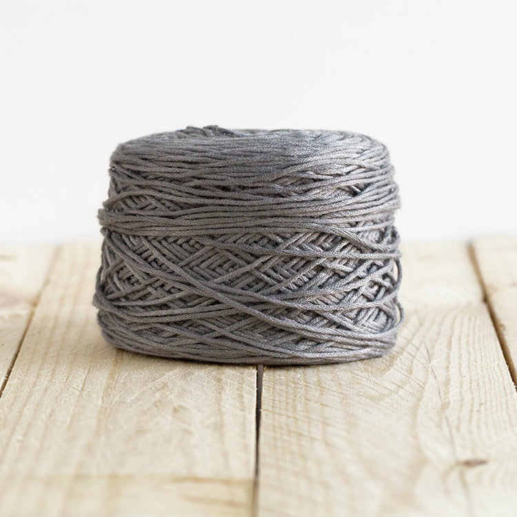 Color 5010, a medium grey cake of yarn.