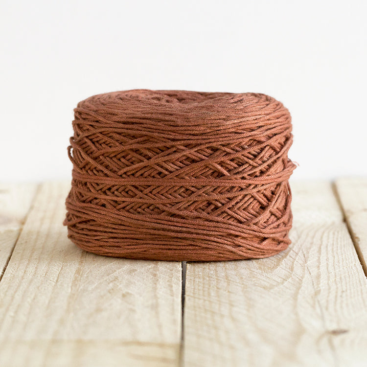 Color 5011, a warm brown cake of yarn.