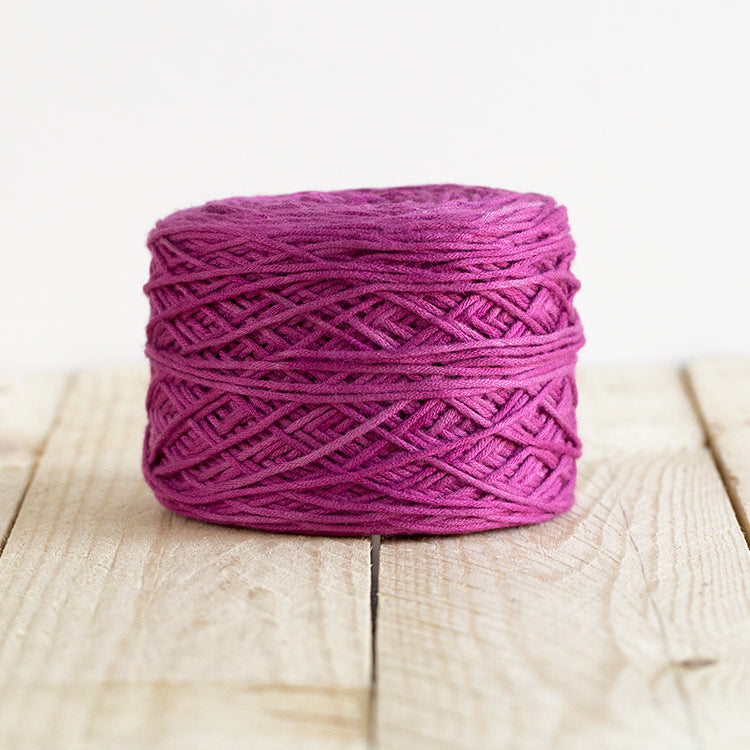 Color 5015, a magenta cake of yarn.