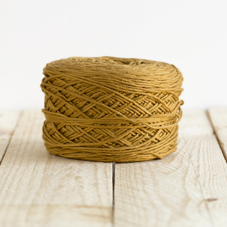 Color 5017, a golden brown cake of yarn.