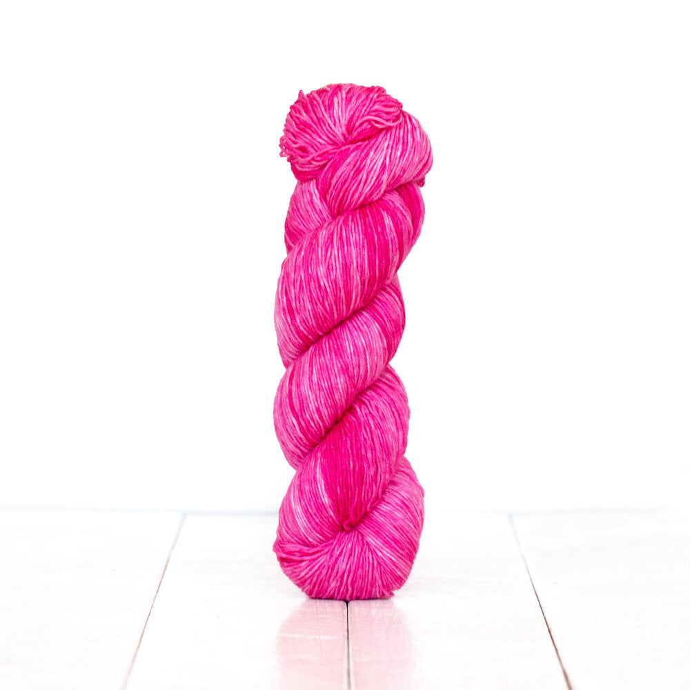 Color 3066, a variegated monochromatic skein of yarn in bright vibrant pink.