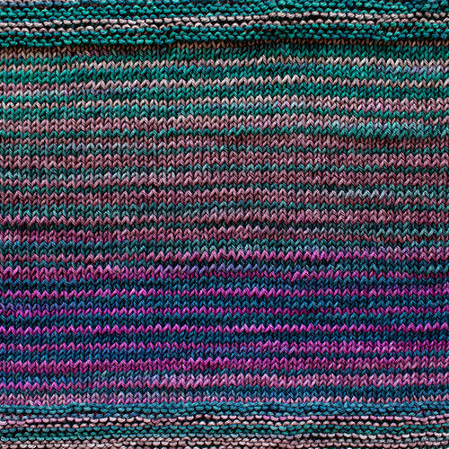 A swatch of Uneek Cotton in the colorway 1071,  stripes in shades of purple, green, blue, and pink.