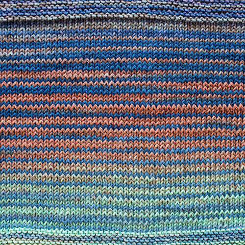A swatch of Uneek Cotton in the colorway 1073, stripes in shades of blue and coral.