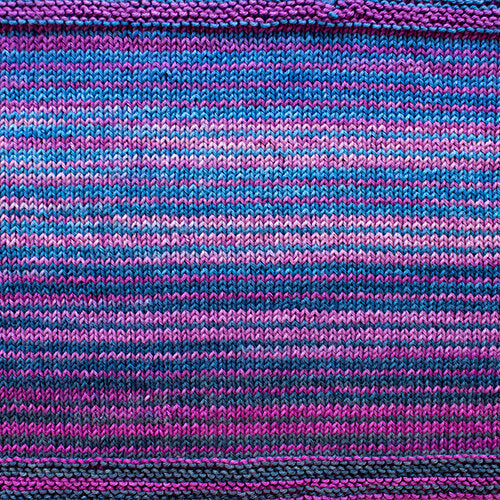 A swatch of Uneek Cotton in the colorway 1074, stripes in shades of blue, purple, and pink.