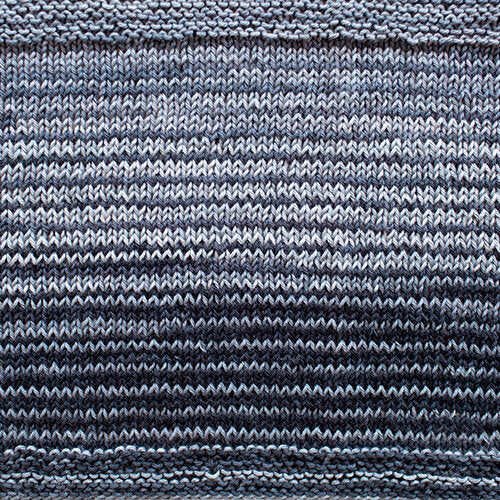 A swatch of Uneek Cotton in the colorway 1076, stripes in shades of grey.