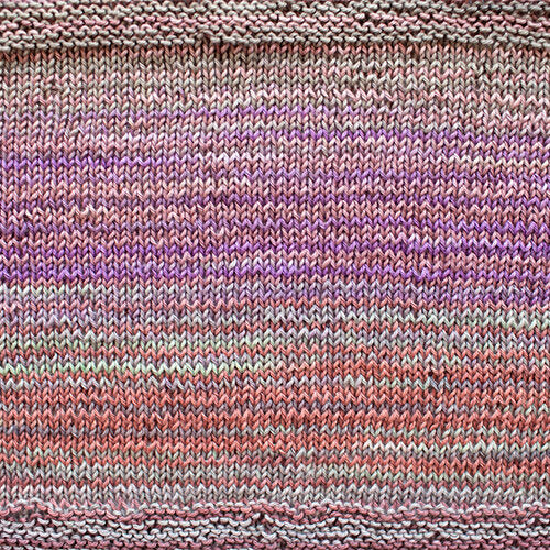A swatch of Uneek Cotton in the colorway 1077, stripes in shades of pink, coral, and tan.