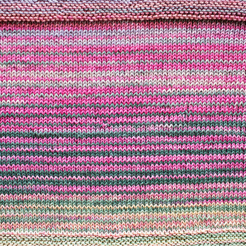 A swatch of Uneek Cotton in the colorway 1078, stripes of pink, grey, lavender, cream, & pale green.