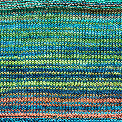 A swatch of Uneek Cotton in the colorway 1081, stripes in shades of blues, greens, and coral.