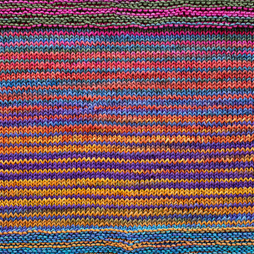 A swatch of Uneek Cotton in the colorway 1085, stripes of blue, pink, purple, & warm yellow.