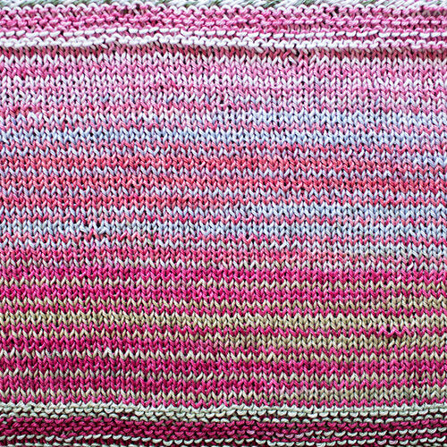 A swatch of Uneek Cotton in the colorway 1086, stripes in shades of pink and off-white.