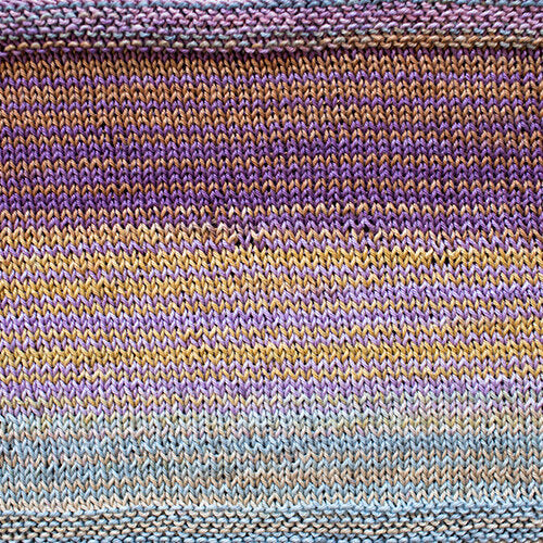 A swatch of Uneek Cotton in the colorway 1094, stripes in shades of purples, yellows, and greys.