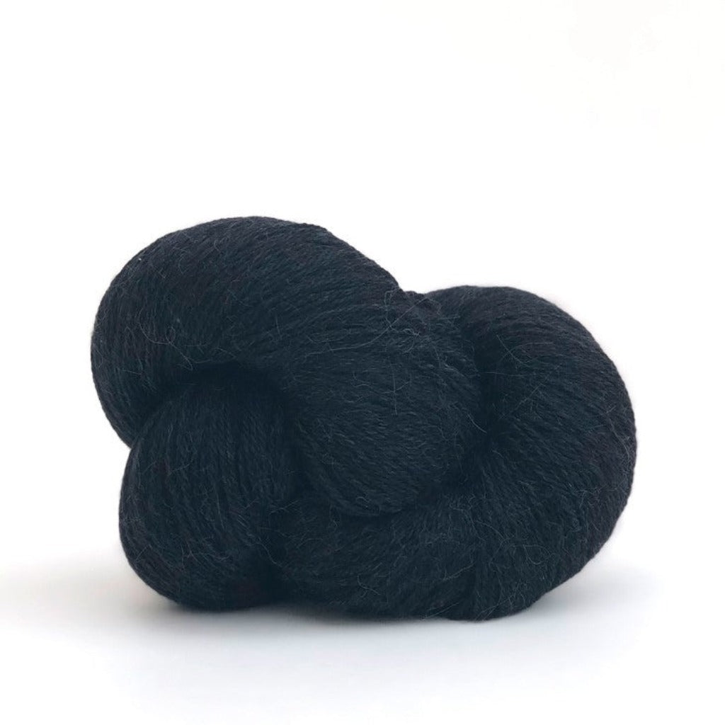 Black 005: A twisted hank of Kelbourne Woolens Perennial Fingering yarn in Black