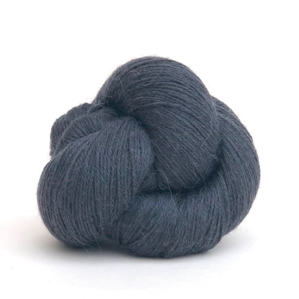 Lead 032: A twisted hank of Kelbourne Woolens Perennial Fingering yarn in a lead grey color