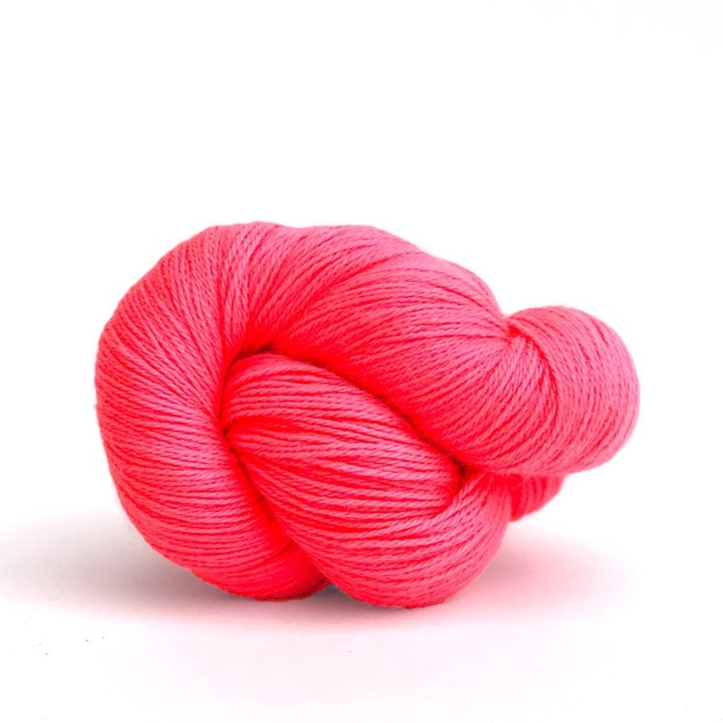 Neon Coral:825 A twisted hank of Kelbourne Woolens Perennial Fingering yarn in a Neon Pinkish orange