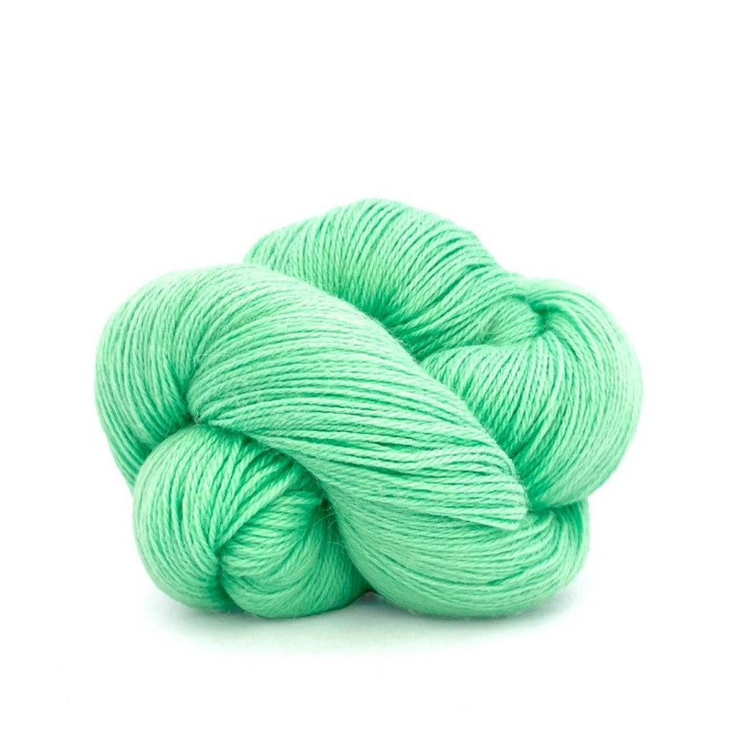 Pastel Green 365:A twisted hank of Kelbourne Woolens Perennial Fingering yarn in a light green color
