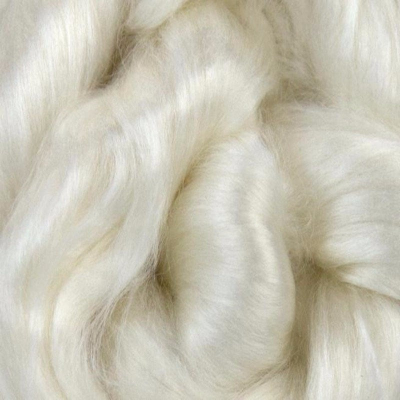 A close up of white undyed rose spinning fiber top.